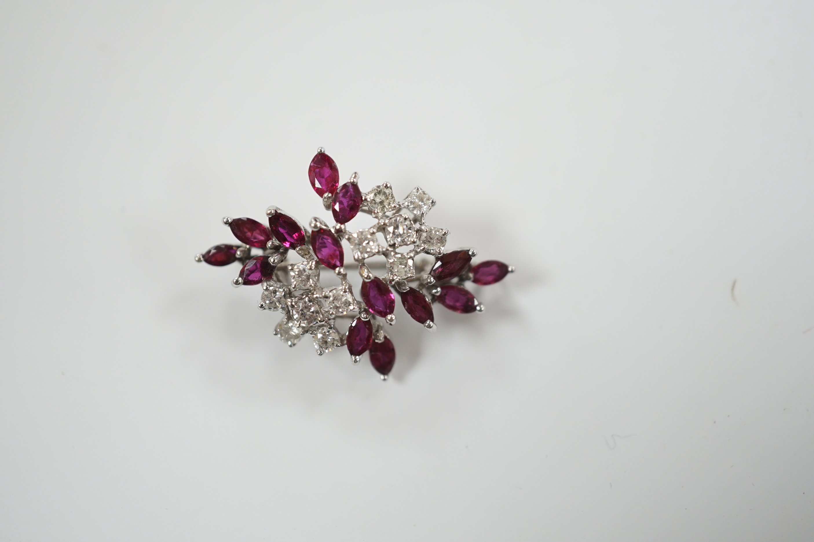 A modern white metal, ruby and diamond cluster set foliate spray pendant brooch, 32mm, gross weight 5.4 grams.